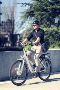 Young businessman on electric bicycle